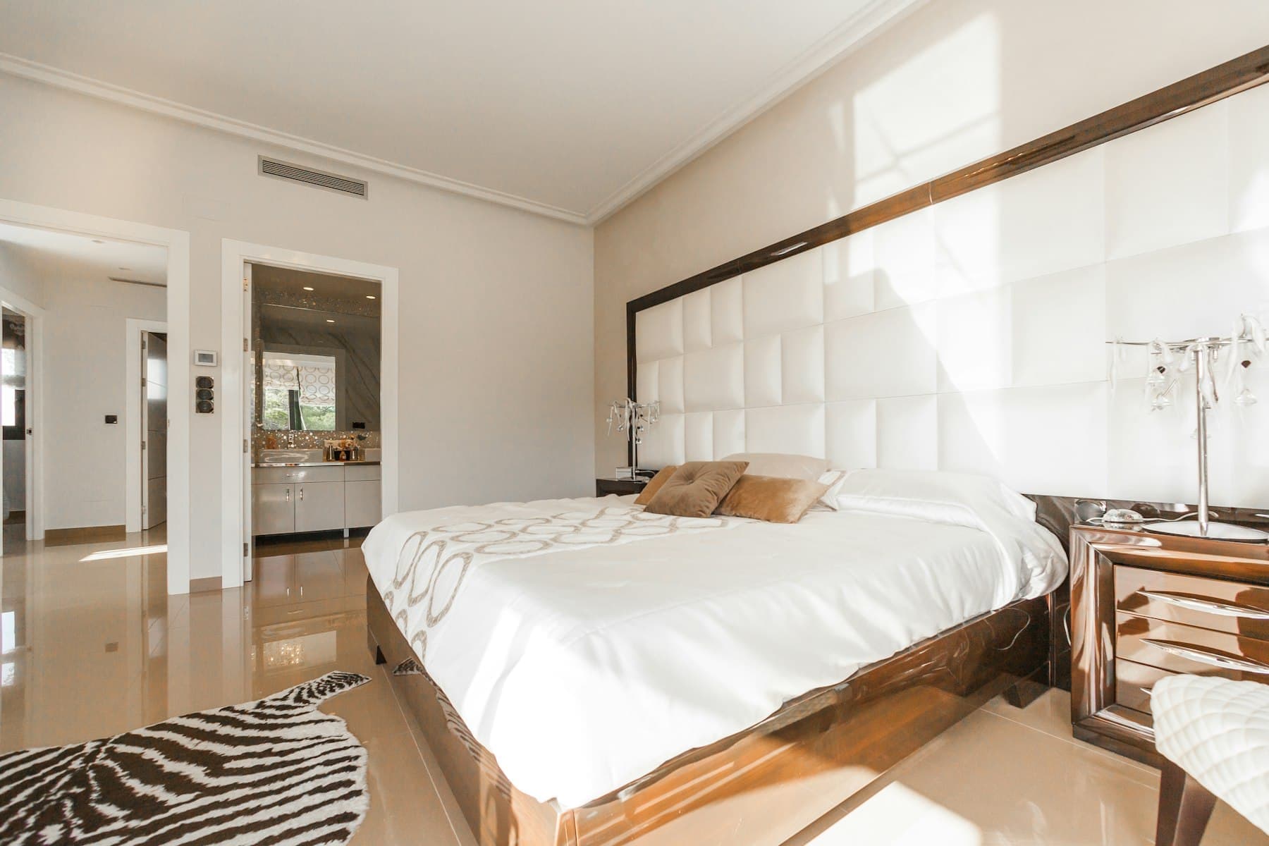 Furnished studio sleeping area with double bed and side tables